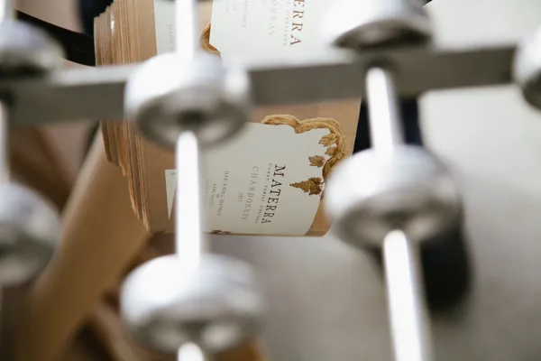 Materra wine bottles on filled bottling line with metal equipment visible