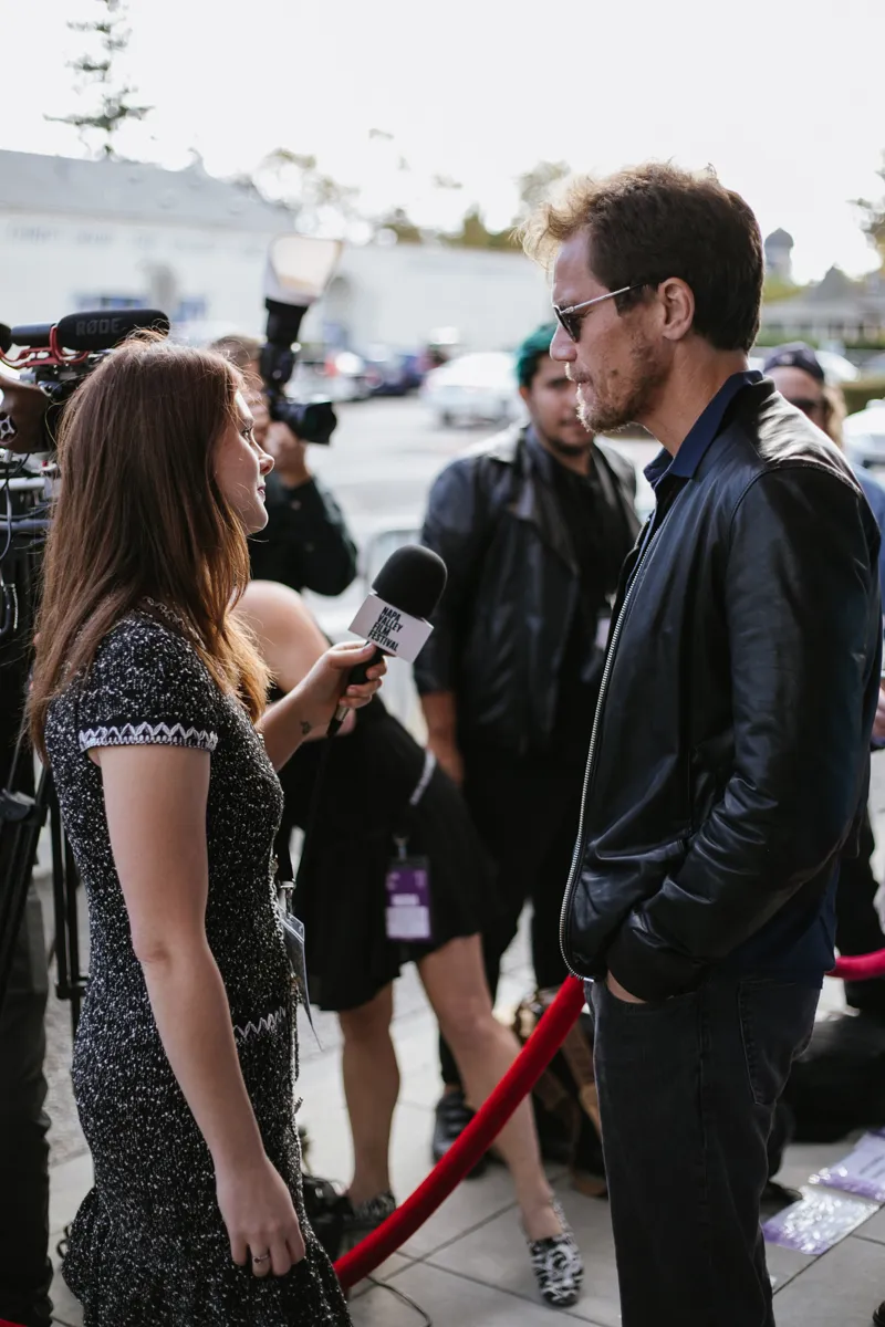 Filmmaker interviewed by journalist at outdoor film festival event