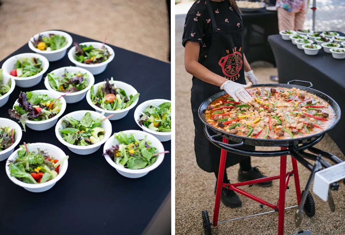 Fresh salads and server with large paella skillet at party